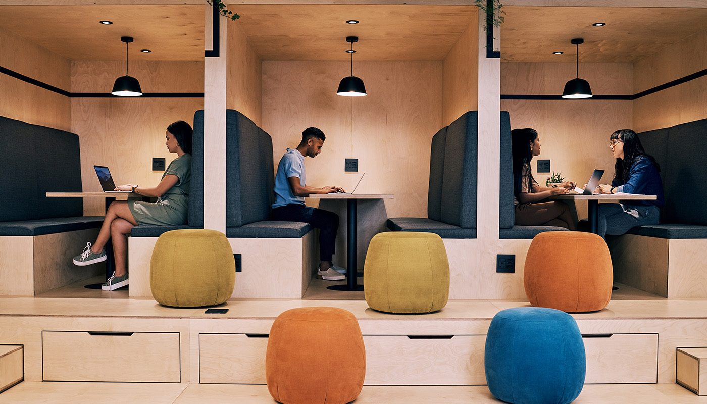 A group of professionals gathered around a table in a modern office, sharing ideas in a lively, collaborative discussion.
